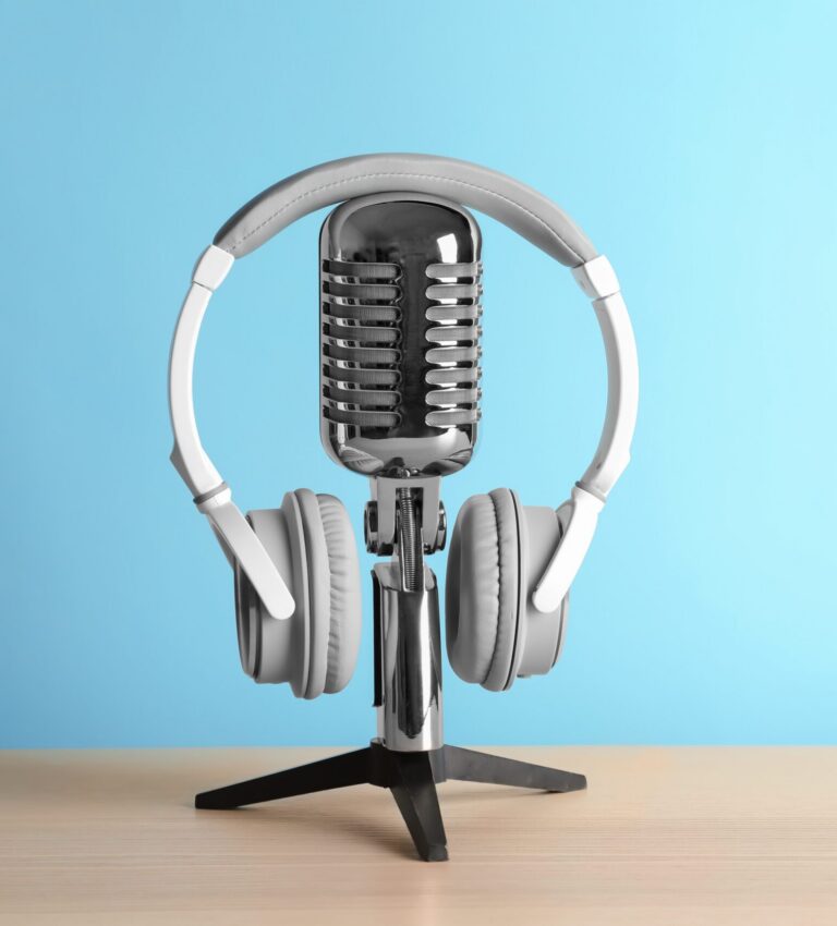 Retro,Microphone,And,Headphones,On,Table,Against,Blue,Wall | Podcast Marketing for Brands | | Site Hub