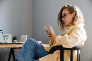Young,Curly,Serious,Woman,In,Glasses,With,Phone,Sitting,By | AMA’s X Study | | Site Hub