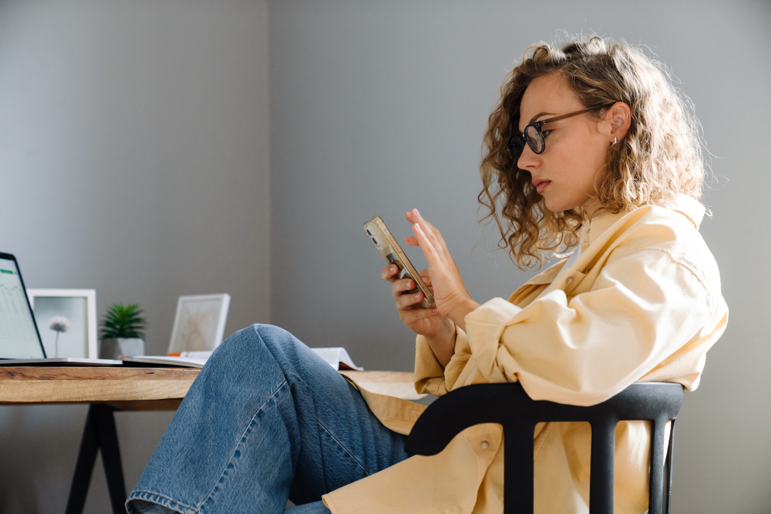 Young,Curly,Serious,Woman,In,Glasses,With,Phone,Sitting,By | AMA’s X Study | | Site Hub